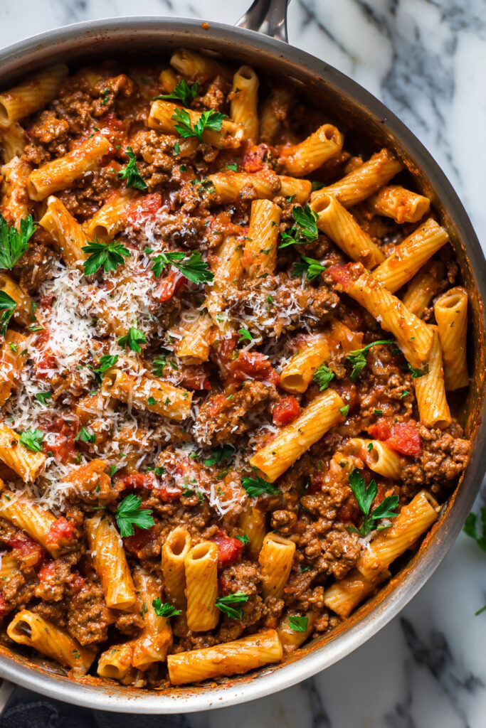 One Pot Creamy Beef Pasta simmering in creamy tomato sauce